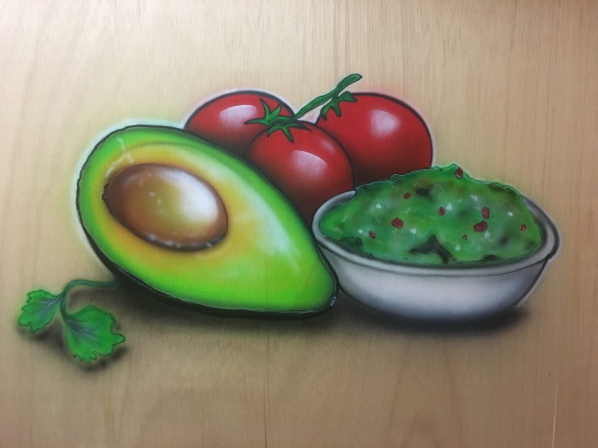 Avocado and tomato on wood
