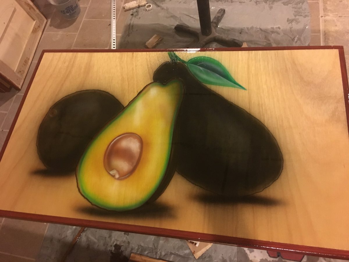 Avocado still life on wood